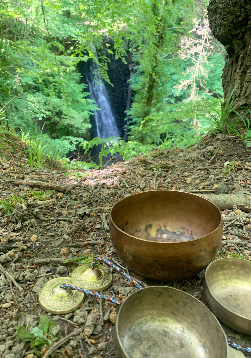 Tibetan sound meditation bowls overlooking Falling Foss waterfall 