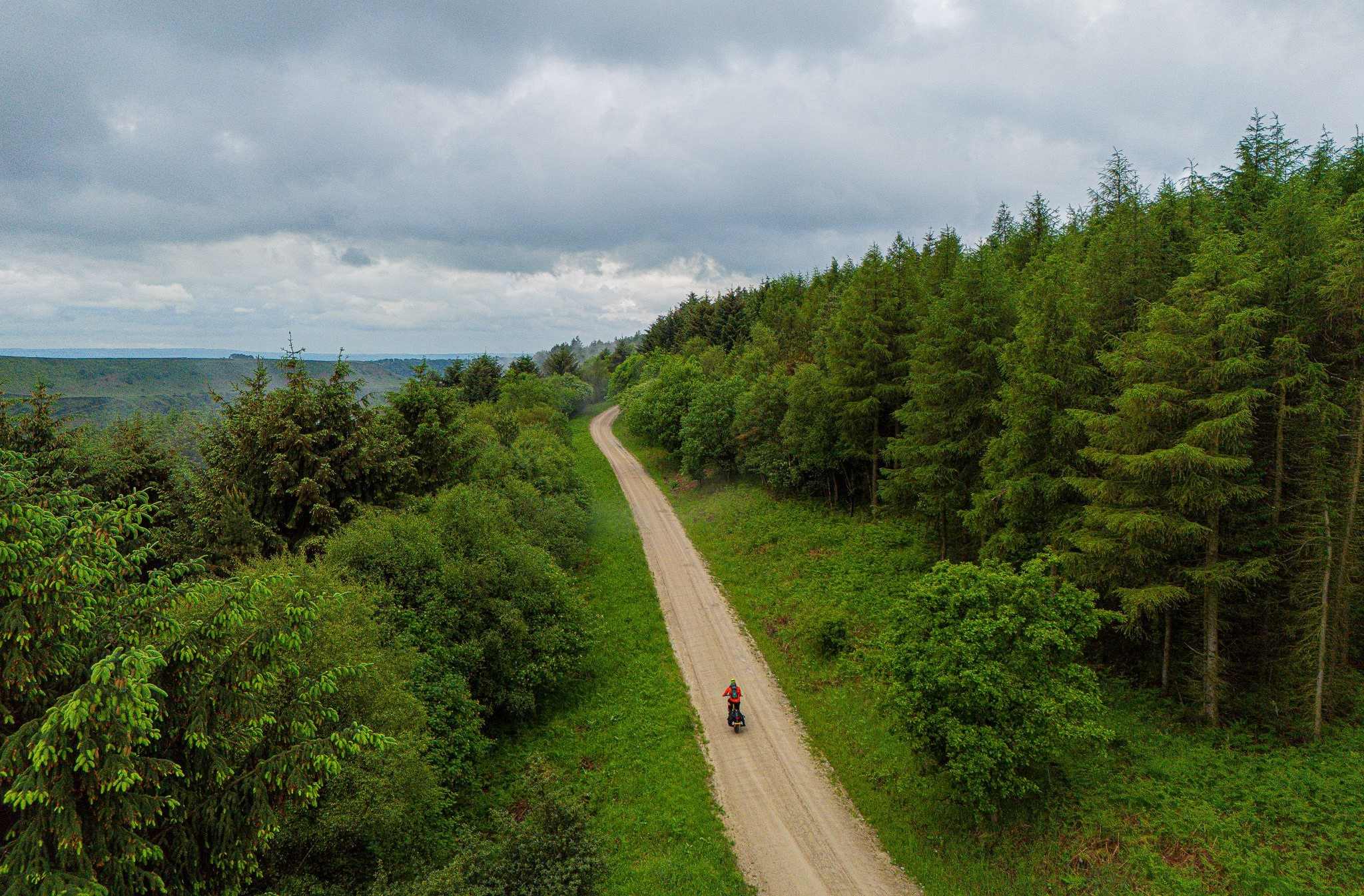 Aerial shot of cyclist going through forest credit Markus Stitz