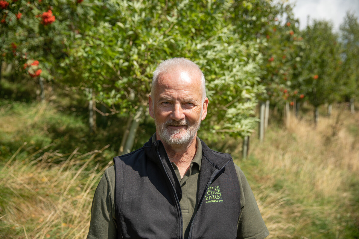 Landowner Mark Hayes of White Lodge Farm. Mark is stood among a woodland that is seven years old. Credit Charlie Fox.