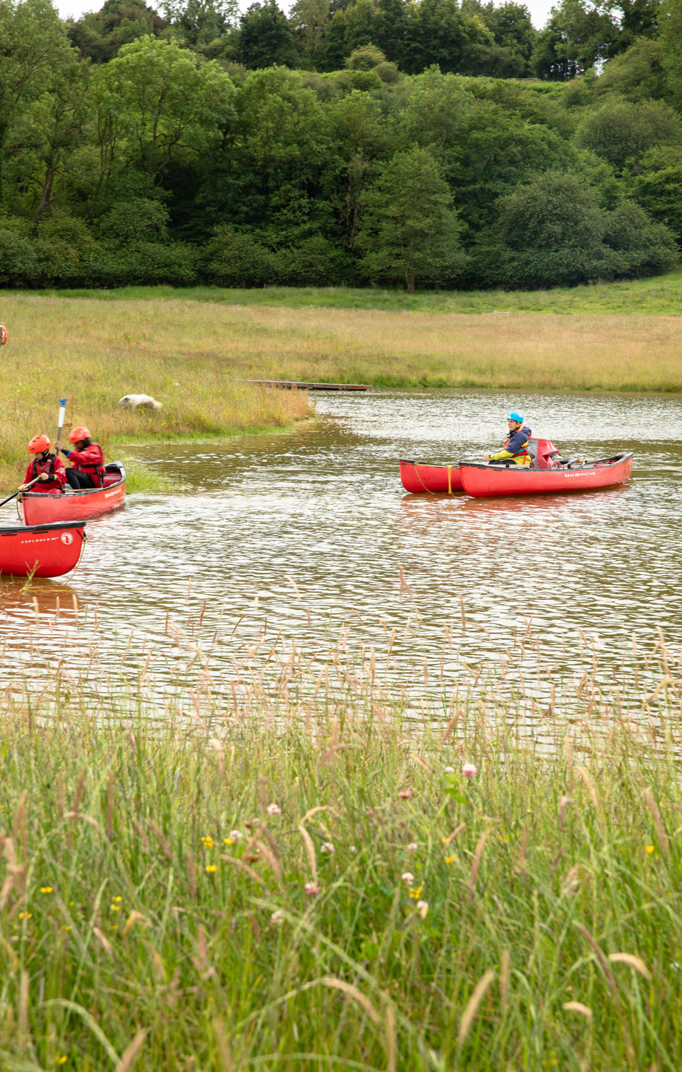 People on a large pond / lake in a canoe. Credit Charlie Fox.