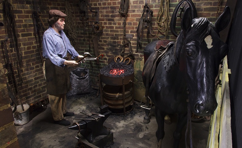 Blacksmith re-shoeing a horse